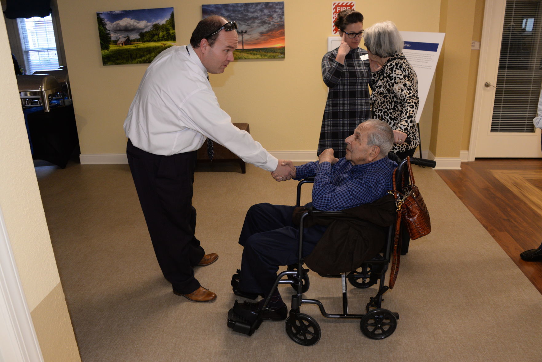 Charlie Moore shakes hands with Woody Shadid